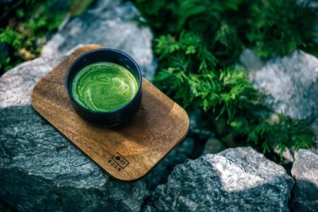 Cup of matcha on a wooden board